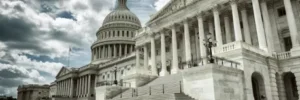 The United States Capitol building under a partly cloudy sky.