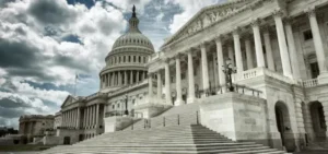 The United States Capitol building under a partly cloudy sky.