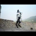 A robot is walking along the Great Wall of China under a hazy sky.