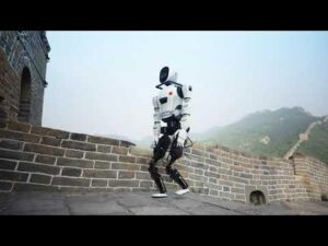 A robot is walking along the Great Wall of China under a hazy sky.